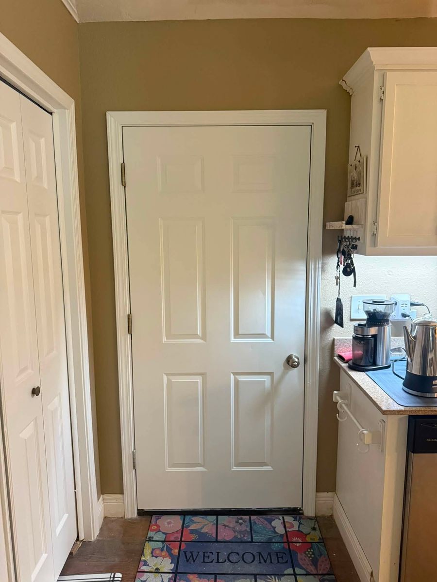 Finished white pantry door and trim in a kitchen